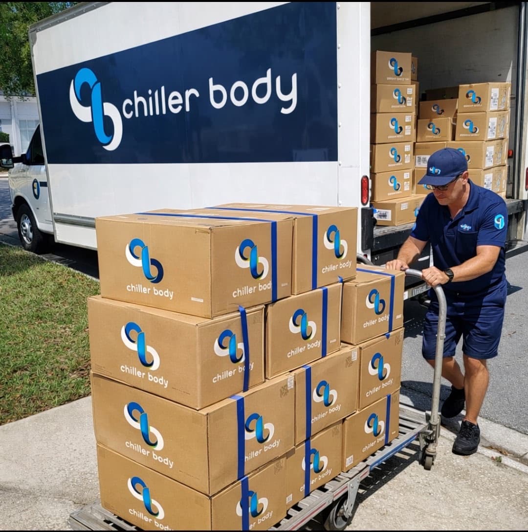 Chiller Body branded boxes loaded on a dolly from a delivery truck for bulk wholesale orders